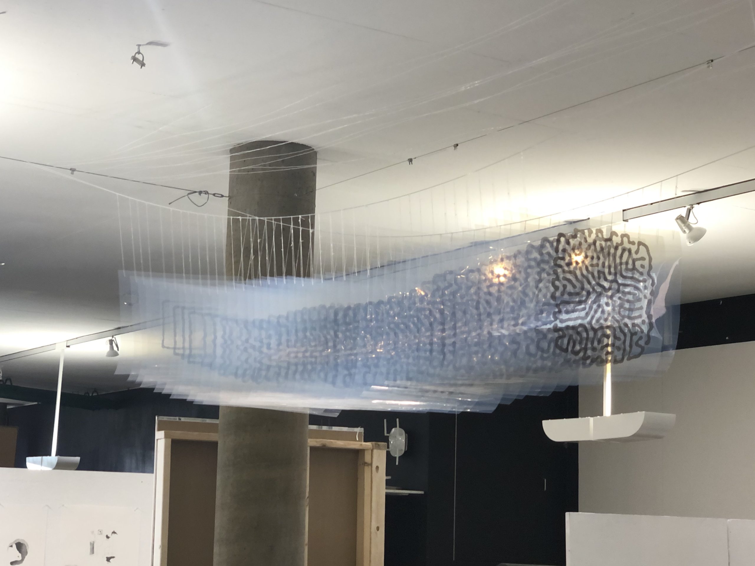 Side view of my artwork consisting of a series of transparent printed plastic sheets