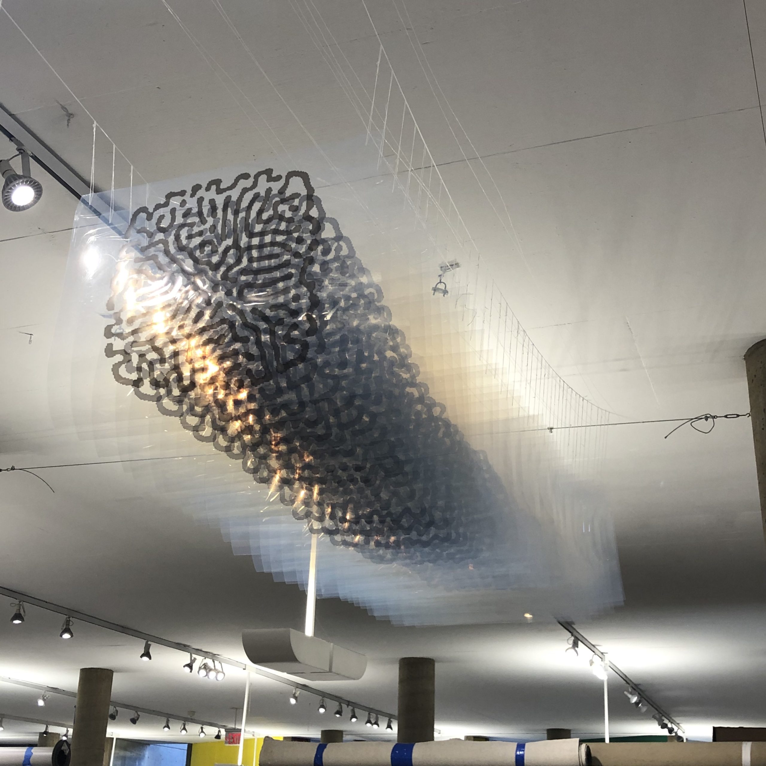 Frontal view of my artwork consisting of a series of transparent printed plastic sheets