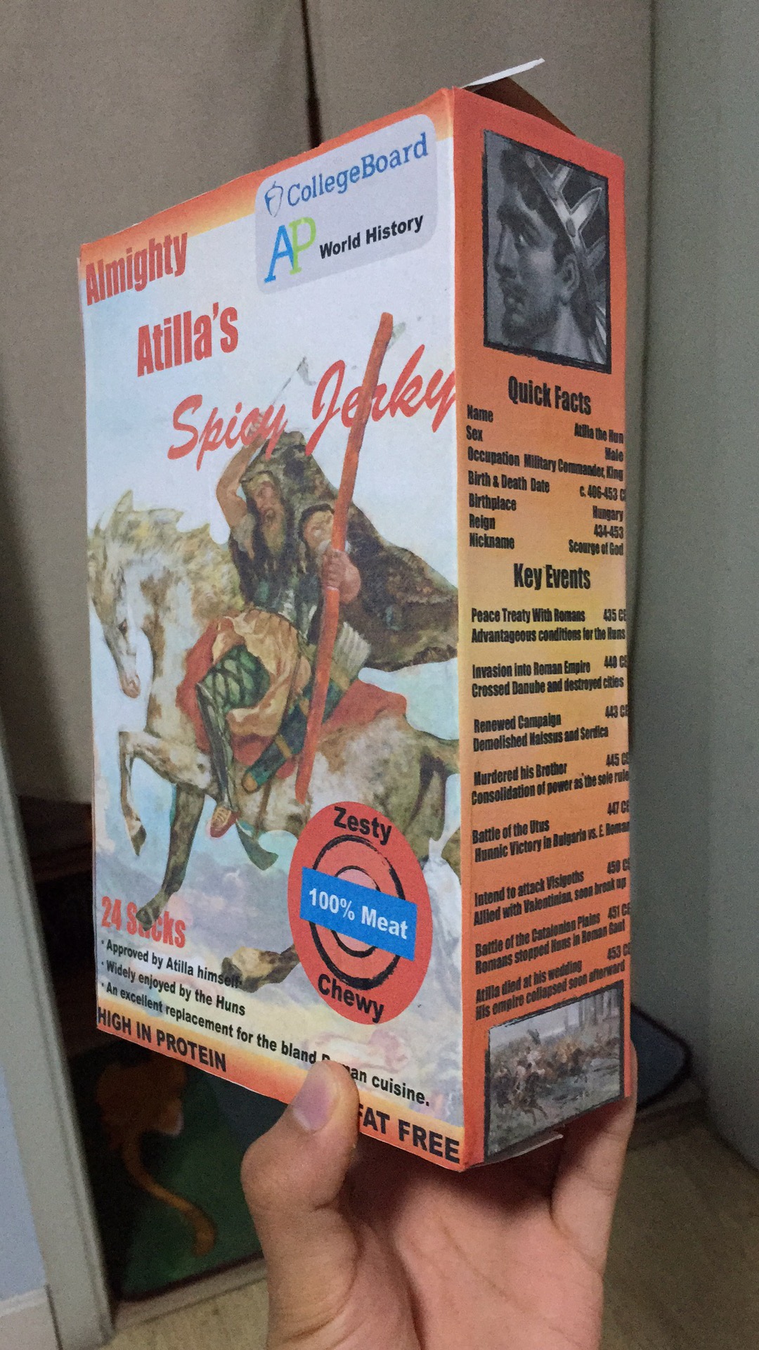 Front of a box showing Attila the Hun holding a long meat stick in his hand